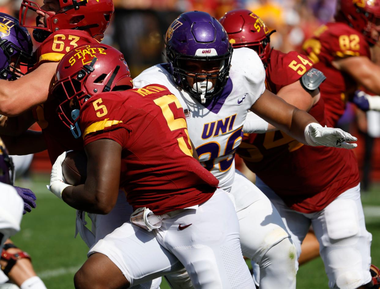 AMES, IA - SEPTEMBER 2: Running back Cartevious Norton #5 of the Iowa State Cyclones rushes for yards as defensive lineman Khristian Boyd #99 of the Northern Iowa Panthers defends in the second half of play at Jack Trice Stadium on September 2, 2023 in Ames, Iowa. The Iowa State Cyclones won 30-9 over the Northern Iowa Panthers.(Photo by David Purdy/Getty Images)