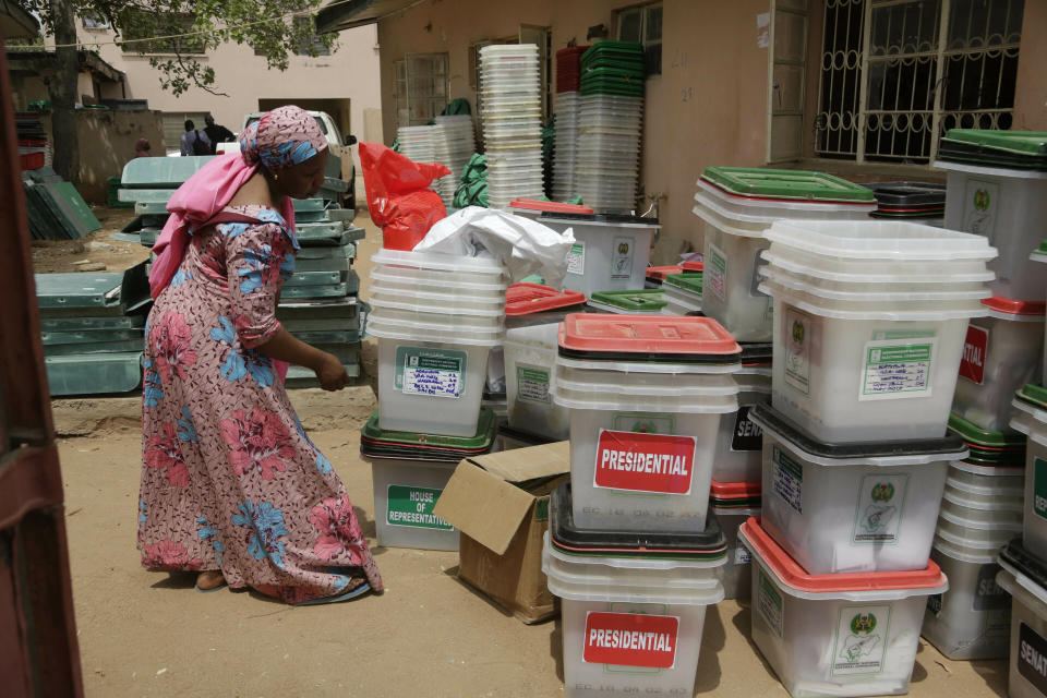 An electoral worker checks ballot boxes at the electoral commission office in Yola, Nigeria, Sunday, Feb. 24, 2019. Vote counting continued Sunday as Nigerians awaited the outcome of a presidential poll seen as a tight race between the president and a former vice president. (AP Photo/Sunday Alamba)