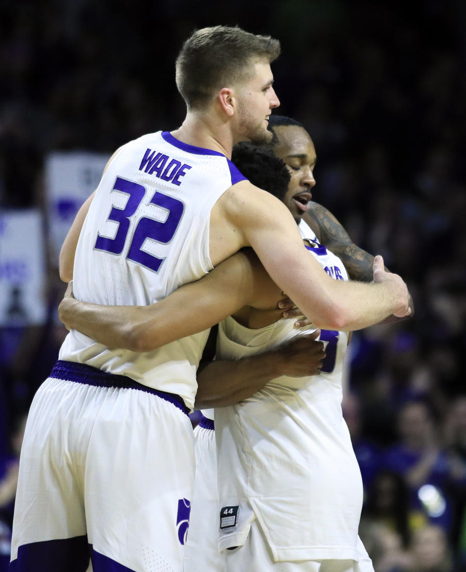 Kansas State seniors Dean Wade (32), Barry Brown Jr., back, and Kamau Stokes, middle, hug as they are replaced during the second half of an NCAA college basketball game against Oklahoma in Manhattan, Kan., Saturday, March 9, 2019. Kansas State defeated Oklahoma 68-53. (AP Photo/Orlin Wagner)