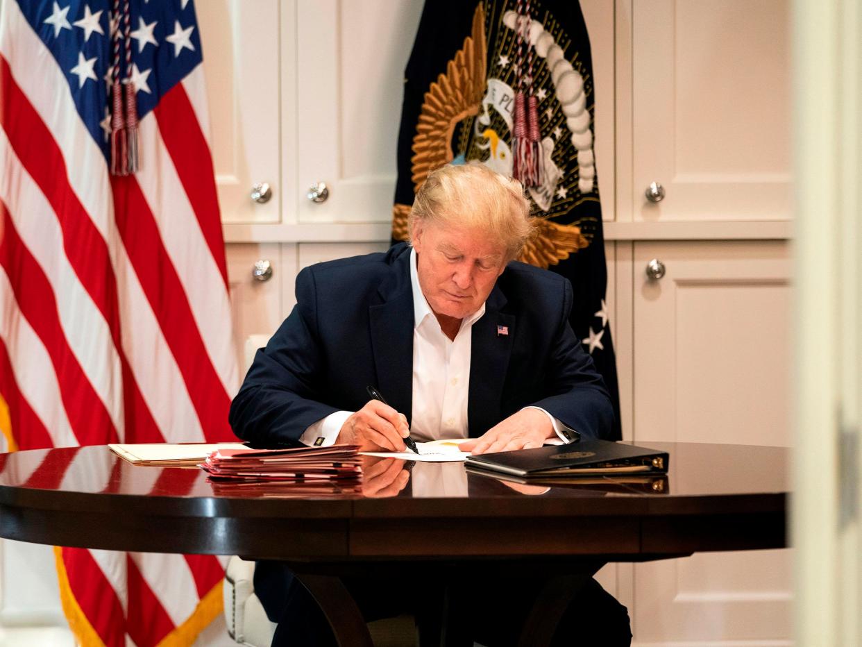 This White House handout photo released 4 October 2020 shows US president Donald Trump working in the Presidential Suite at Walter Reed National Military Medical Centre in Bethesda, Maryland on 3 October 2020, after testing positive for Covid-19 ((AFP photo /The White House/Joyce N. Boghosian/Handout))