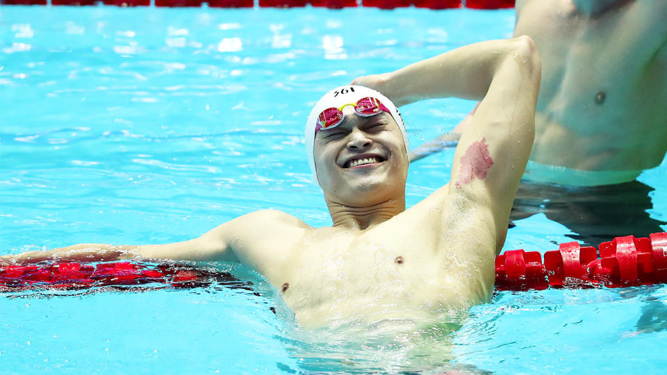 Sun Yang (L) of China celebrates as Clyde Lewis of Australia looks on after the Men's 200m Freestyle Final on day three of the Gwangju 2019 FINA World Championships at Nambu International Aquatics Centre on July 23, 2019 in Gwangju, South Korea. (Photo by Catherine Ivill/Getty Images)