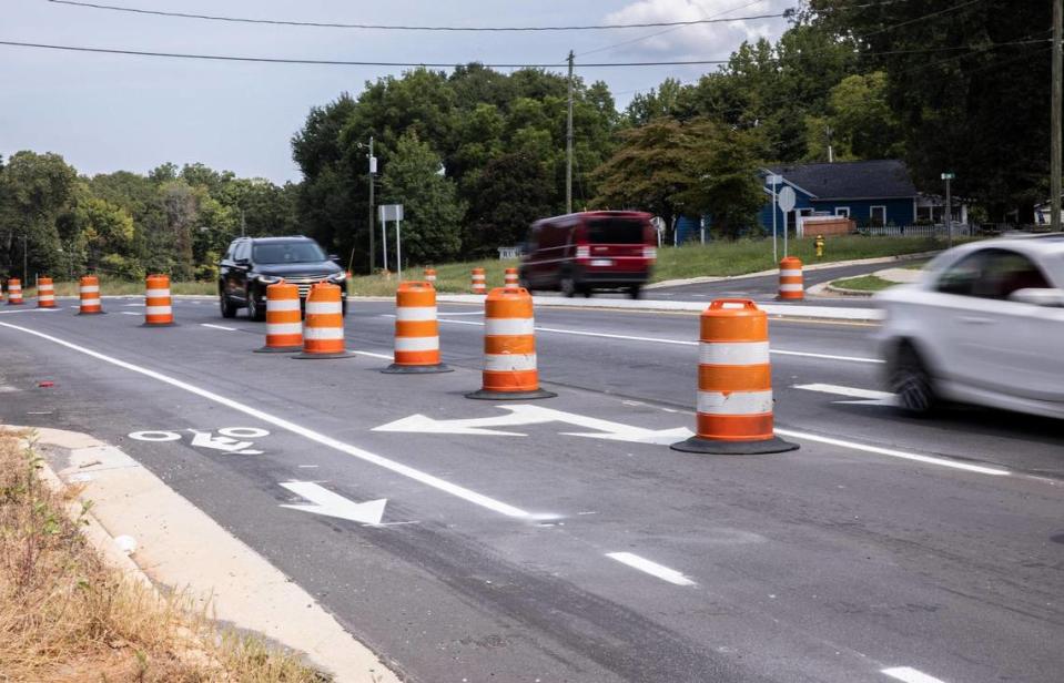 Drivers on N.C. 273 in Mount Holly pass a closed lane on Beatty Drive on Wednesday, Sept. 15, 2021. A $15.3 million widening of a 1.3-mile stretch of N.C. 273 appeared to be finished months ago, yet the barrels still block drivers.