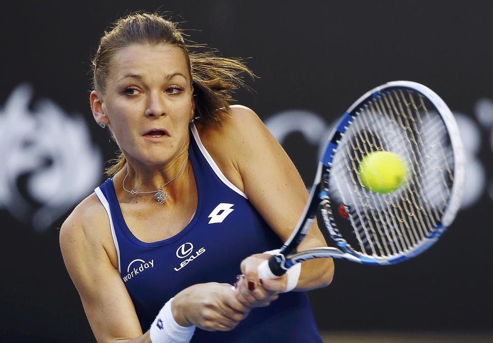 Radwanska of Poland hits a return to Venus of the U.S. during their women's singles match at the Australian Open 2015 tennis tournament in Melbourne