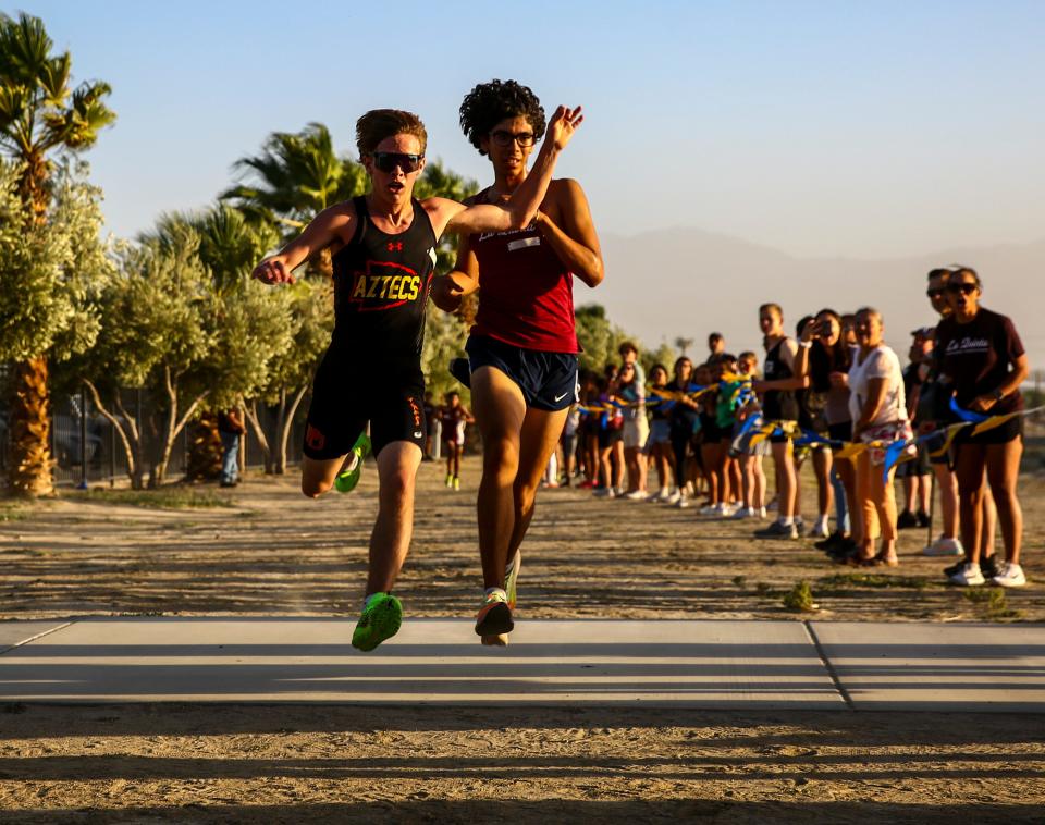 Palm Desert's Simon Cook reaches to get just ahead of La Quinta's Jorge Mendoza during the boys' race of the first DEL cross country meet of the year at Xavier College Preparatory High School in Palm Desert, Calif., Wednesday, Sept. 20, 2023.