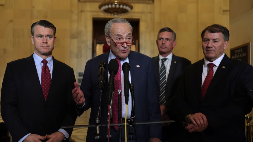 U.S. Senate Minority Leader Sen. Chuck Schumer (D-NY) speaks as (L-R) Sen. Todd Young (R-IN), Sen. Martin Heinrich (D-NM) and Sen. Michael Rounds (R-SD) listen after a meeting on AI at the Kennedy Caucus Room at Russell Senate Office Building on November 1, 2023 on Capitol Hill in Washington, DC. An AI Insight Forum was held to discuss the future practice of Artificial Intelligence. - Alex Wong/Getty Images