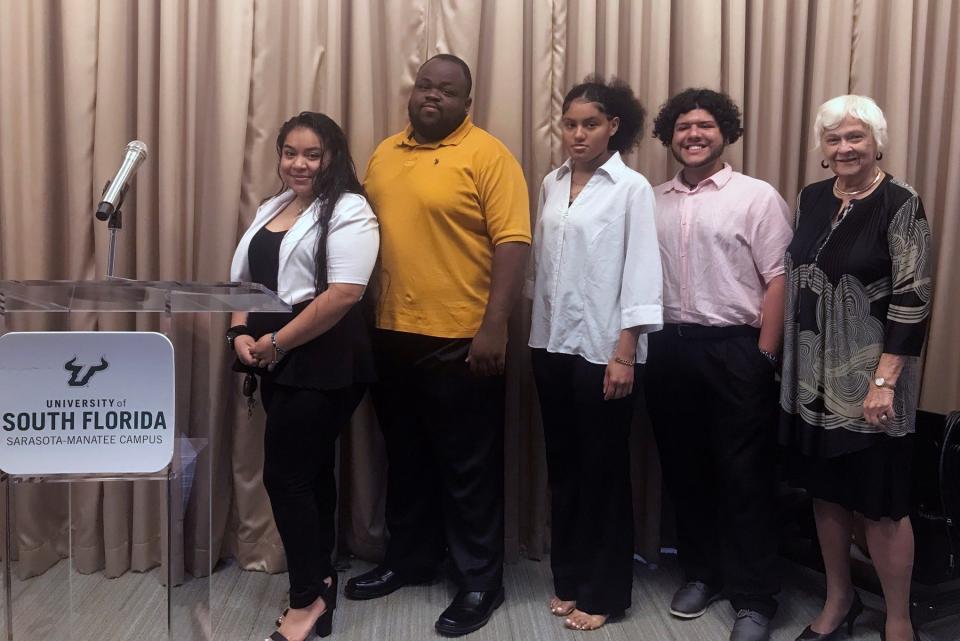 Recent graduates and Achievers program alumni include, from left, Regina Mantero, Jamal Watson, Ana Samedi and Javier Chavez with Dr. Karen A. Holbrook, Regional Chancellor for USF Sarasota-Manatee.