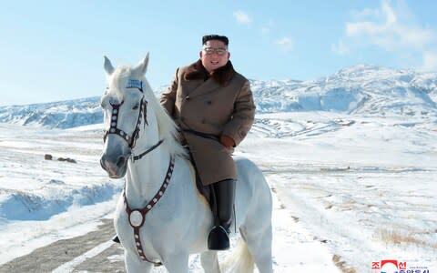 Kim Jong-un takes a moment to smile on the back of a horse  - Credit: HOGP/AP