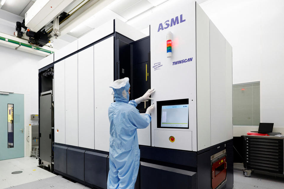 An assembly engineer works on a TWINSCAN DUV lithography system at ASML in Veldhoven, Netherlands June 16, 2023. REUTERS/Piroschka van de Wouw