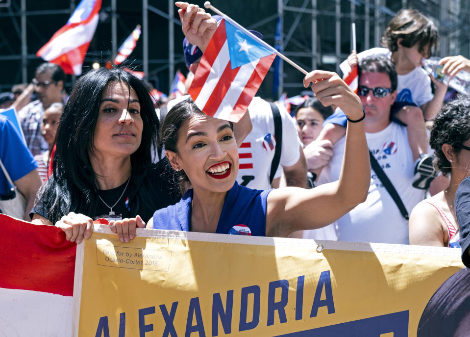 Rep. Alexandria Ocasio-Cortez, D-N.Y., center, takes part in the National Puerto Rican Day Parade Sunday, June 9, 2019, in New York. (AP Photo/Craig Ruttle))