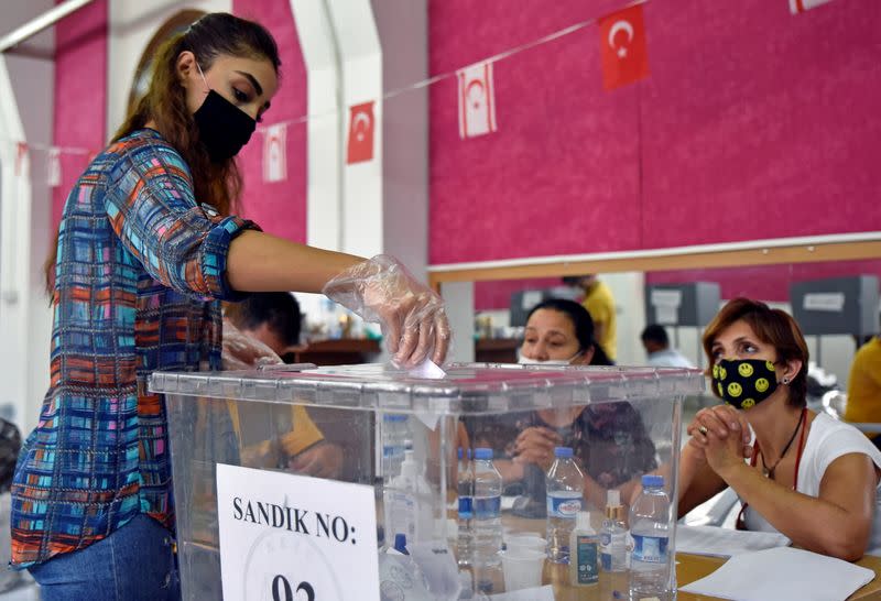 A woman casts her vote at a polling station during Turkish Cypriot presidential election in northern Nicosia