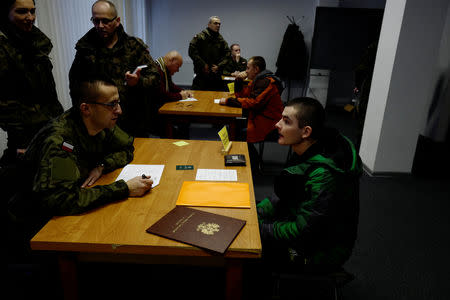 Recruits register on their first day of 16-day basic training for Poland's Territorial Defence Forces, at a military unit in Siedlce, Poland, December 1, 2017. REUTERS/Kacper Pempel/Files