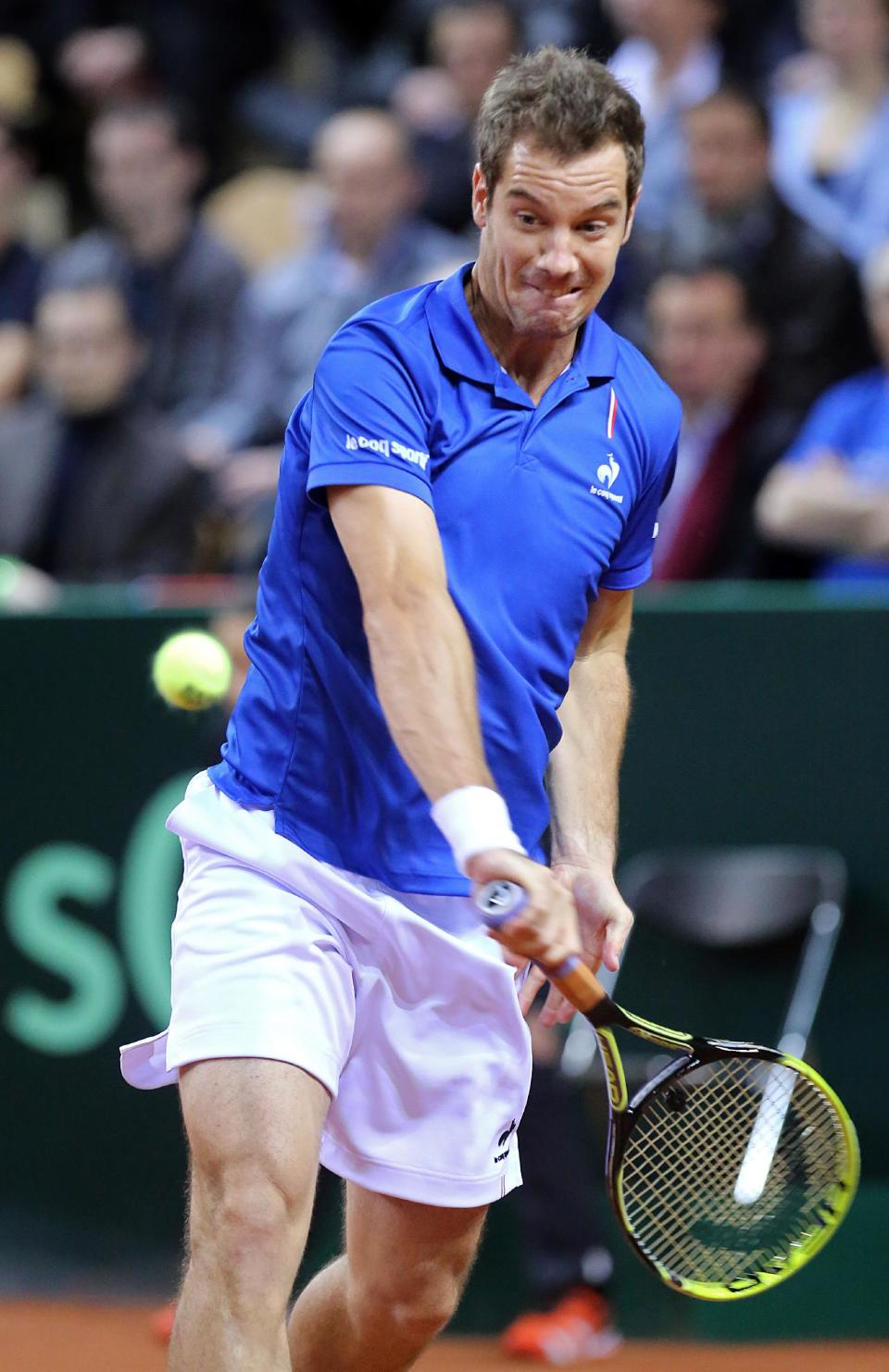 France's Richard Gasquet returns the ball to Australia's Nick Kyrgios during their singles match, in the first round of the Davis Cup between France and Australia, in La Roche sur Yon, western France, Friday Jan. 31, 2014.(AP Photo/Remy de la Mauviniere)