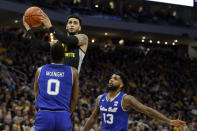 Marquette's Markus Howard is called for a charging foul against Seton Hall's Quincy McKnight during the first half of an NCAA college basketball game Saturday, Feb. 29, 2020, in Milwaukee. (AP Photo/Aaron Gash)