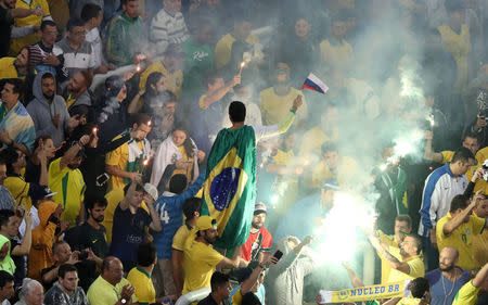 Football Soccer - Brazil v Paraguay - World Cup 2018 Qualifiers - Arena Corinthians stadium, Sao Paulo, Brazil - 28/3/17 - A Brazil's fan celebrates with a flag of Russia, the host of the World Cup 2018. REUTERS/Paulo Whitaker