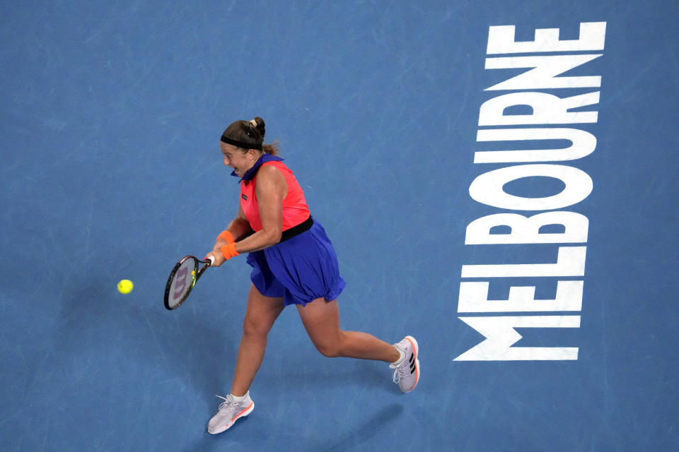 Jelena Ostapenko of Latvia plays a backhand return to Elena Rybakina of Kazakhstan during their quarterfinal match at the Australian Open tennis championship in Melbourne, Australia, Tuesday, Jan. 24, 2023. (AP Photo/Ng Han Guan)