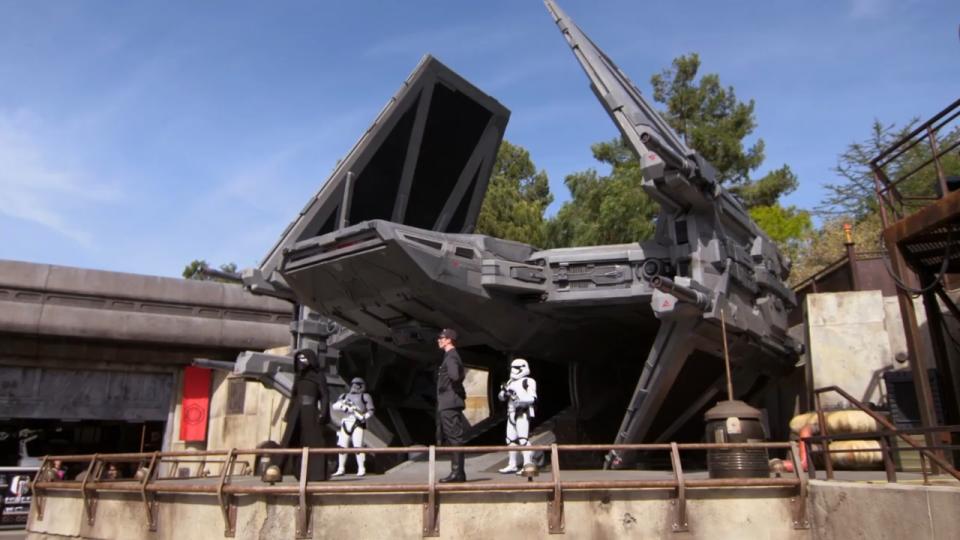First Order Tie echelon with Kylo Ren, Stromtroopers, and First Order officer standing in front of it, at Star Wars: Galaxy's Edge, Disneyland