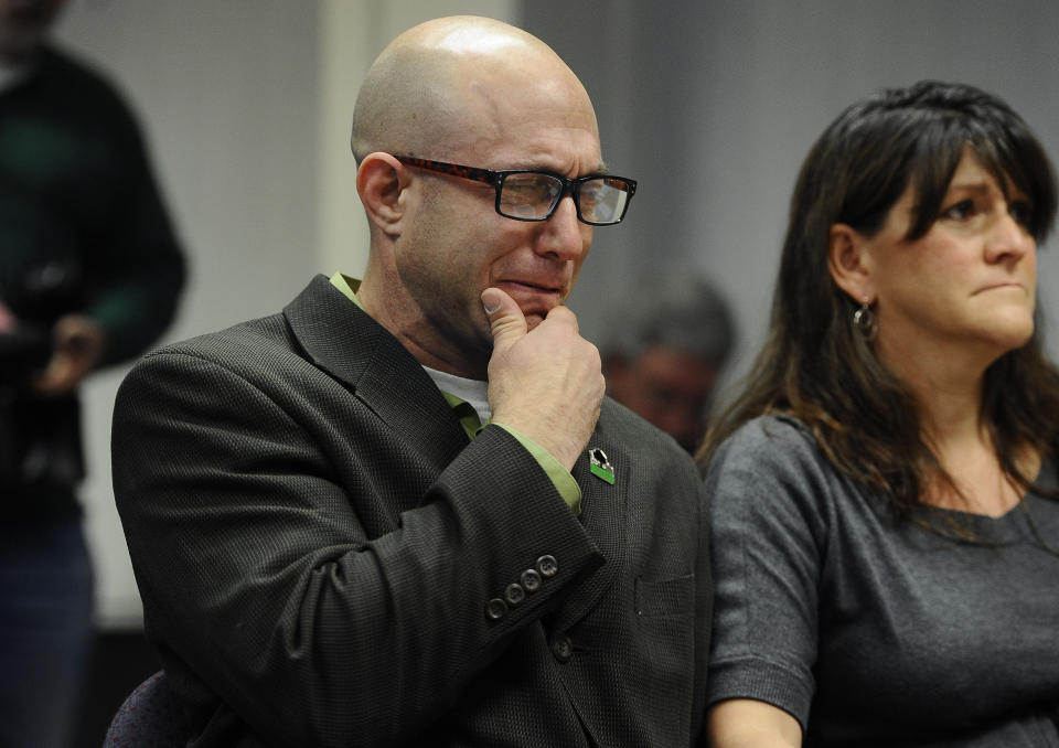 Jeremy Richman, left, weeps as he watches a video of his daughter, Sandy Hook Elementary school shooting victim Avielle Richman, as wife Jennifer Hensel, right, sits beside him during a presentation to the Sandy Hook Advisory Commission in Newtown, Conn., Nov. 14, 2014. (Photo: Jessica Hill/AP)