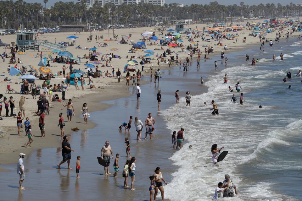 Visitors crowd the beach July 12, 2020, in Santa Monica, Calif., amid the coronavirus pandemic.