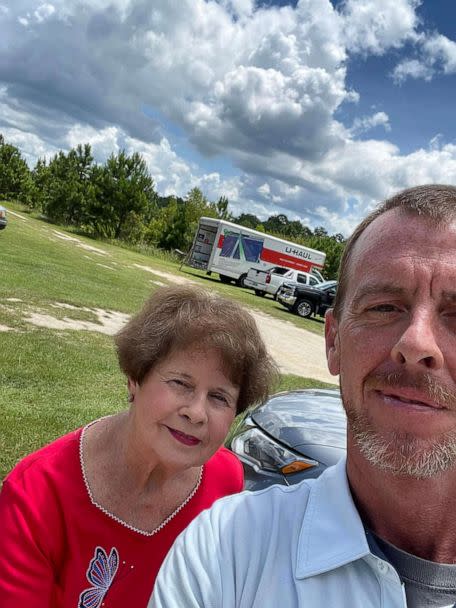 PHOTO: Sean Peacock stands with his mom in front of the U-haul truck in Eastman, Georgia, that will carry the 21 memorial benches to Uvalde, Texas. (Sean Peacock)