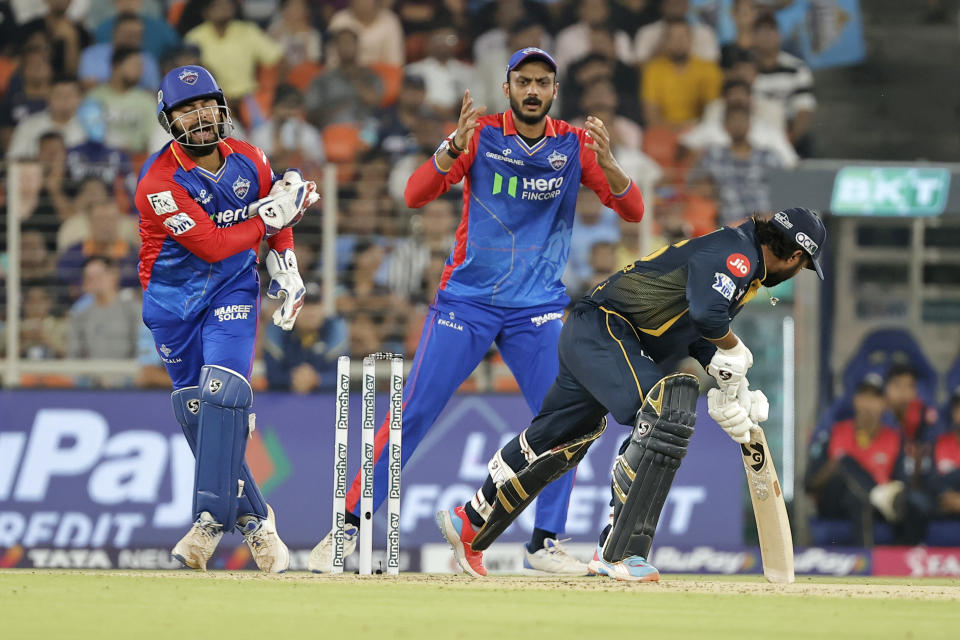 Delhi Capitals' captain Rishabh Pant, left, appeals unsuccessfully for the stumping of Gujarat Titans' Rahul Tewatia during the Indian Premier League cricket match between Delhi Capitals and Gujarat Titans in Ahmedabad, India, Wednesday, April 17, 2024. (AP Photo/Pravin Indrekar)