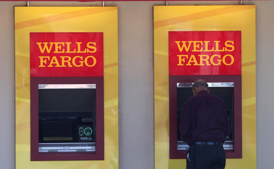 SAN BRUNO, CALIFORNIA - AUGUST 08: Wells Fargo customers use the ATM at a bank branch on August 08, 2023 in San Bruno, California. The Securities and Exchange Commission has fined Wells Fargo and several other banks over $500 million for using private messaging apps to discuss company business without keeping records. Wells Fargo received the largest fine of $200 million. (Photo by Justin Sullivan/Getty Images)