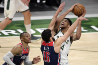 Milwaukee Bucks' Giannis Antetokounmpo drives to the basket against Washington Wizards' Anthony Gill and Russell Westbrook during the second half of an NBA basketball game Wednesday, May 5, 2021, in Milwaukee. (AP Photo/Aaron Gash)