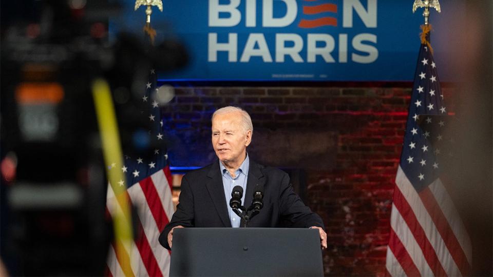 President Joe Biden at podium with US flags behind him