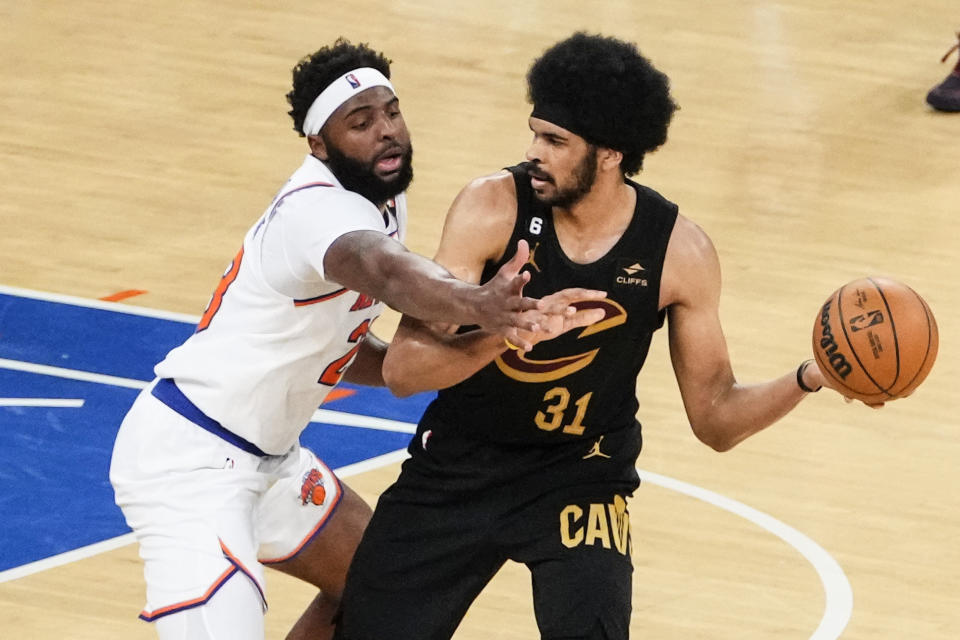 New York Knicks' Mitchell Robinson, left, defends against Cleveland Cavaliers' Jarrett Allen during the first half of Game 3 in an NBA basketball first-round playoff series Friday, April 21, 2023, in New York. (AP Photo/Frank Franklin II)