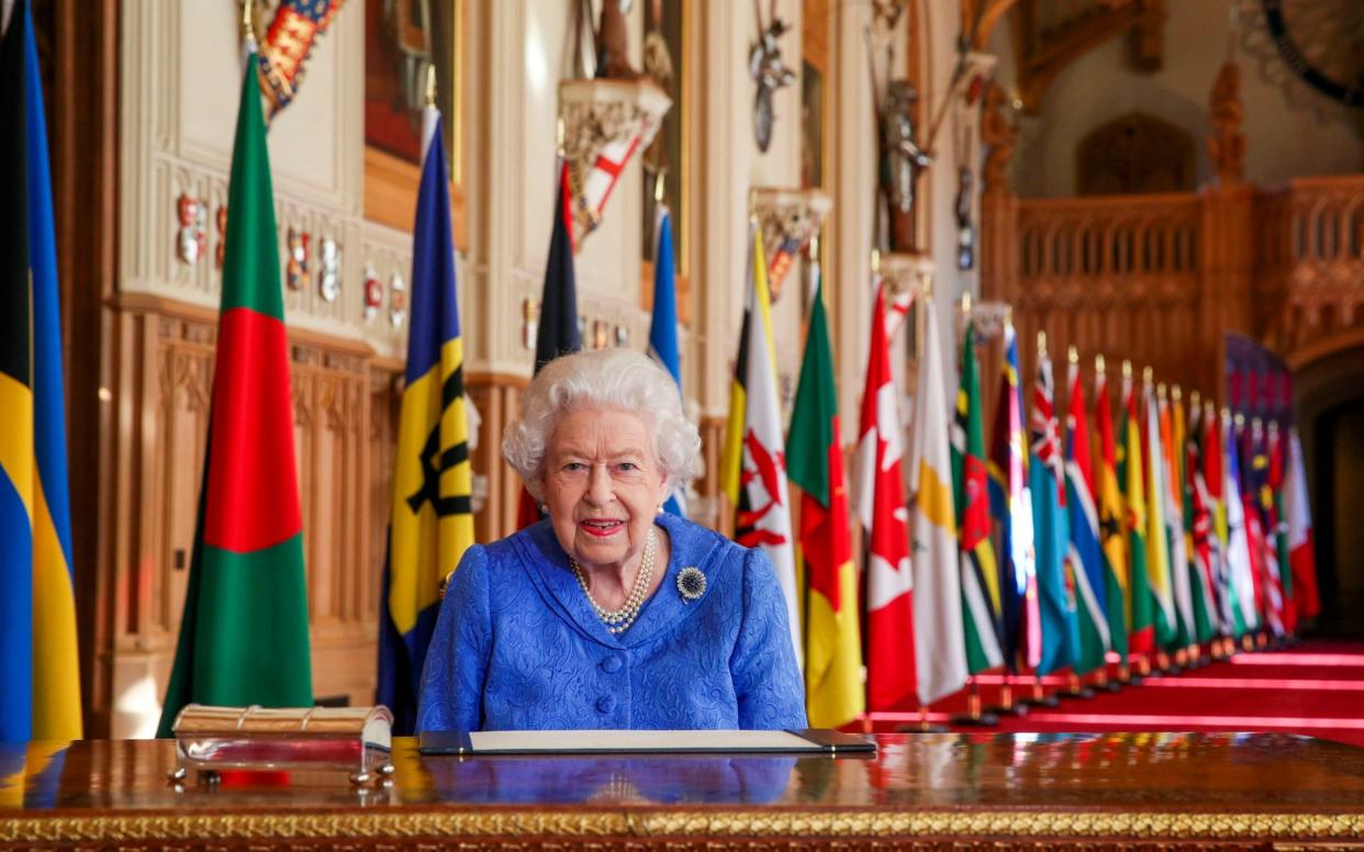 The Queen signs her annual Commonwealth Day Message in St George's Hall at Windsor Castle - PA