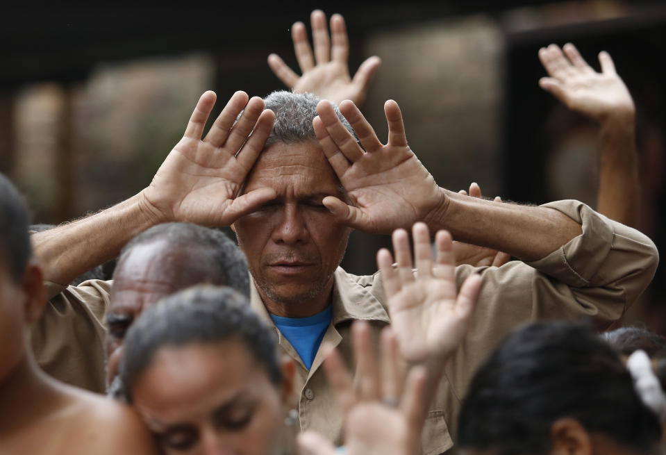 <p>Venezuelan migrants pray before lunch at the “Divina Providencia” migrant shelter run by the diocese of Cucuta, in Cucuta, Colombia, Feb. 23, 2018, on the border with Venezuela. The diocese offers an average of 1000 meals a day for the migrants. (Photo: Fernando Vergara/AP) </p>