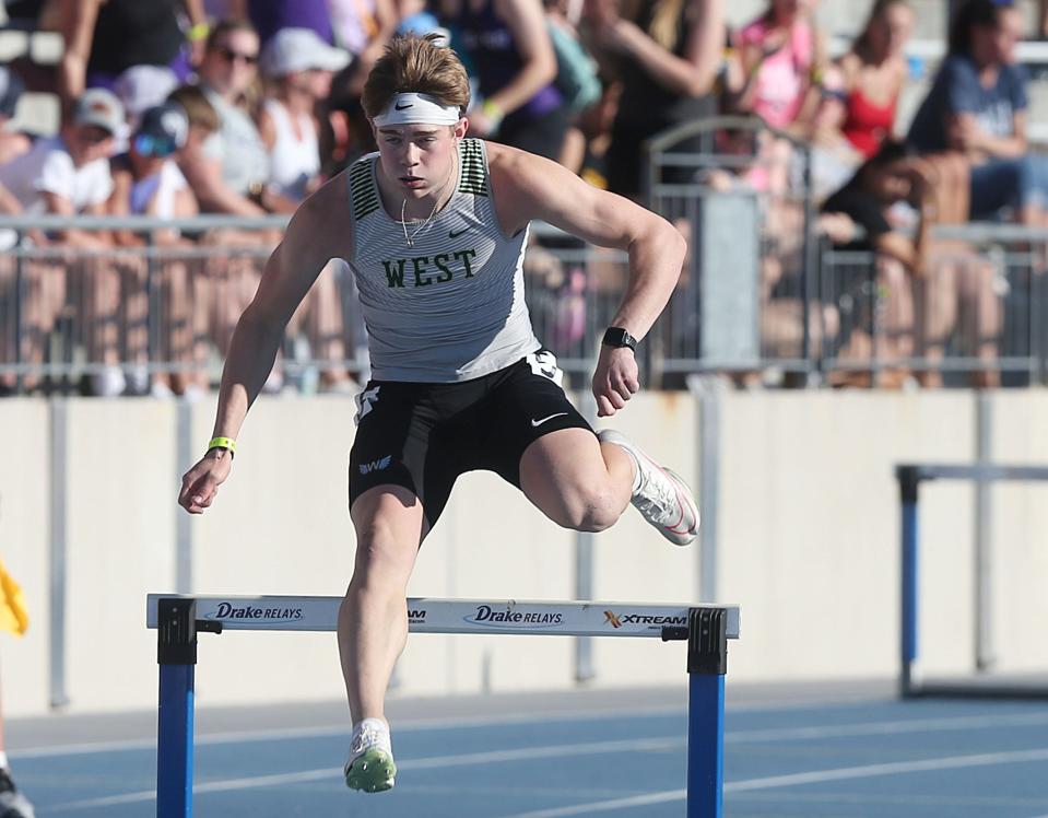 Iowa City West’s Aidan Jacobsen leaps over a hurdle during the 4A boys 400-meter hurdles during the Iowa state track and field meet at Drake Stadium on Friday. Jacobsen won his first individual state title in the event.
