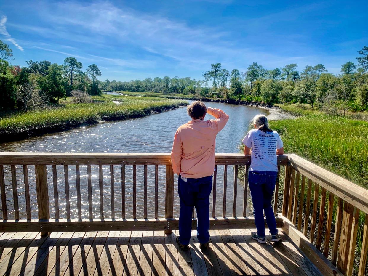 Two board members of the Timucuan Parks Foundation check out the view from the Cedar Point pedestrian bridge. Battles have raged over development in the area for several years, with the latest involving a proposed community center on Cedar Point Road.