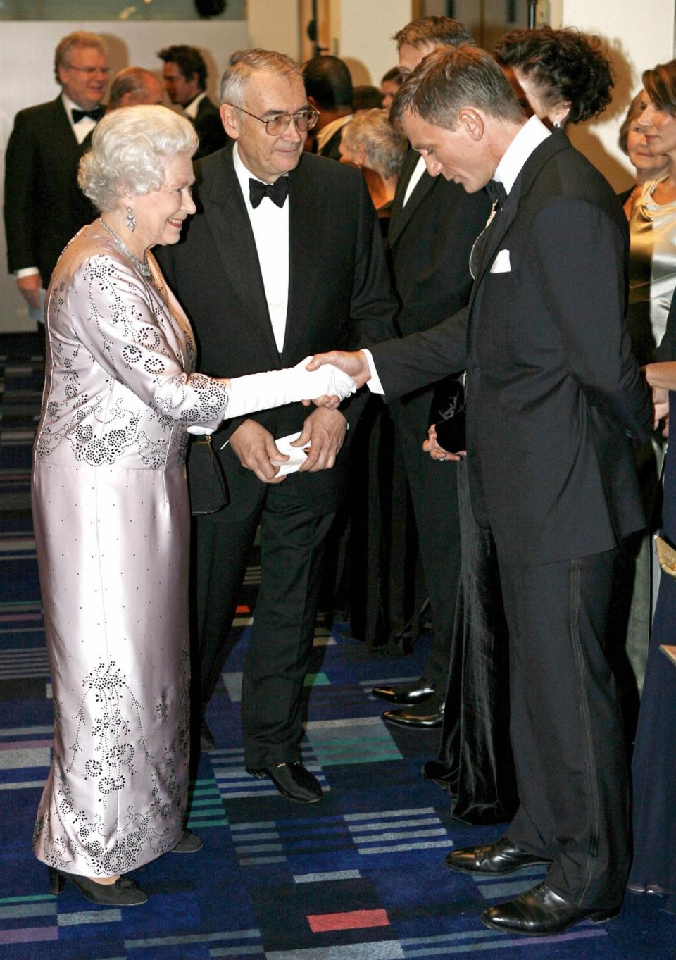 Daniel Craig: Daniel Craig looks downwards as he is presented to the Queen at the world premiere of James Bond film <i>Casino Royale</i> on 14 November 2006. Craig went on to film a James Bond-themed skit with the monarch for the opening ceremony of the London 2012 Olympics (AFP via Getty Images)