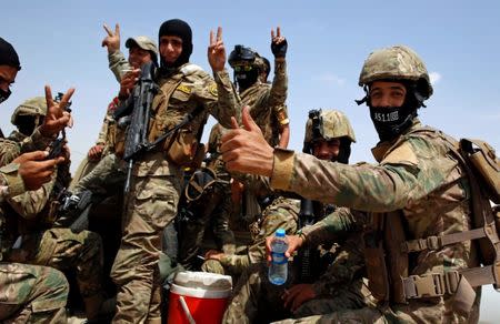 Members of Iraqi forces react before the start of a victory celebration after defeating the Islamic State militants and retaking the Grand al-Nuri Mosque in the Old City in Mosul, Iraq July 2, 2017. REUTERS/Erik De Castro