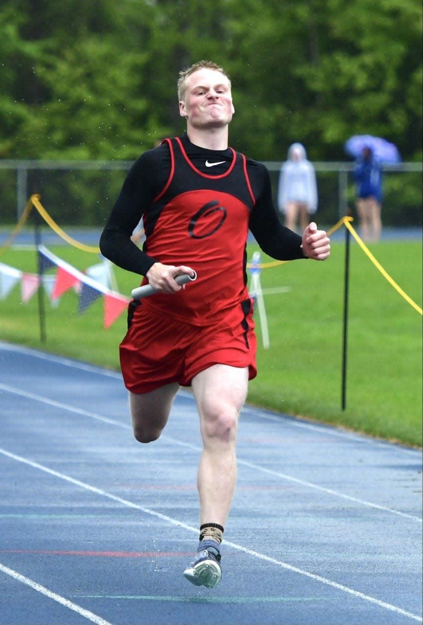 Onaway's Jager Mix runs a leg during a relay event. Mix and the Cardinals finished fourth.