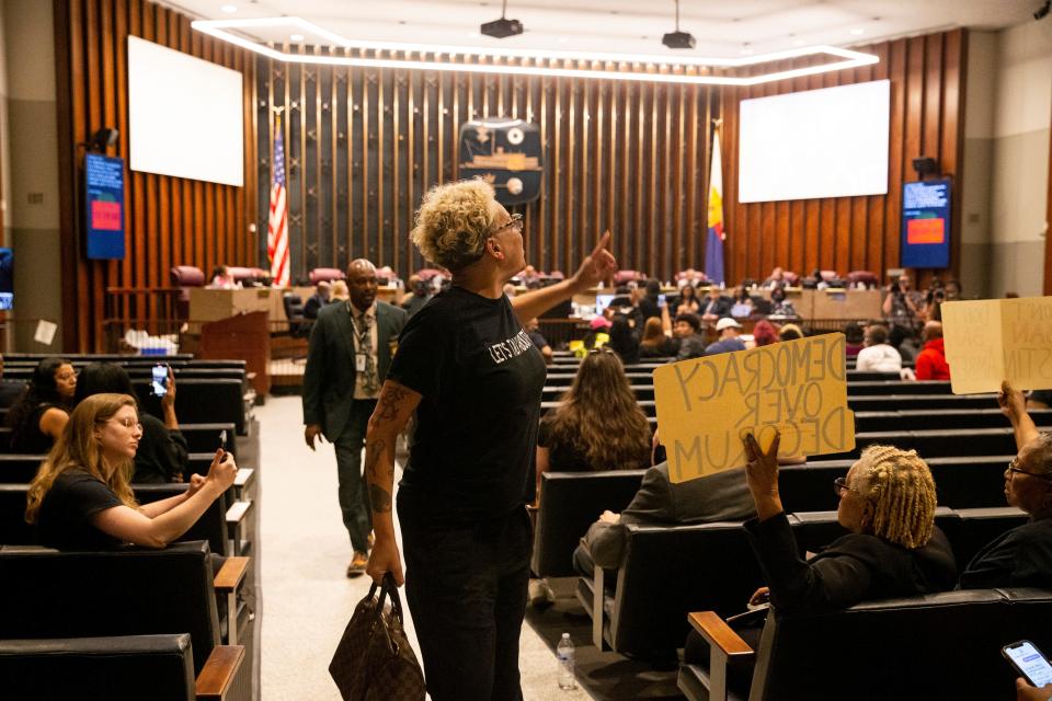 Activist LJ Abraham shouts “you cannot silence the movement” as she leaves the chamber followed by a security officer in protest to multiple individuals being banned from City Council meetings during a Memphis City Council meeting on Tuesday, April 11, 2023. Two items on the agenda were police reform ordinances. The “Achieving Driving Equality” ordinance passed while the other, which had opposition from advocates and questions from council members as to whether it was redundant, was tabled indefinitely. 