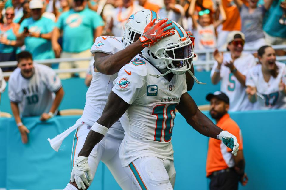 Sep 8, 2024; Miami Gardens, Florida, USA; Miami Dolphins wide receiver Tyreek Hill (10) celebrates with wide receiver Jaylen Waddle (17) after scoring a touchdown against the Jacksonville Jaguars during the third quarter at Hard Rock Stadium. Mandatory Credit: Sam Navarro-Imagn Images