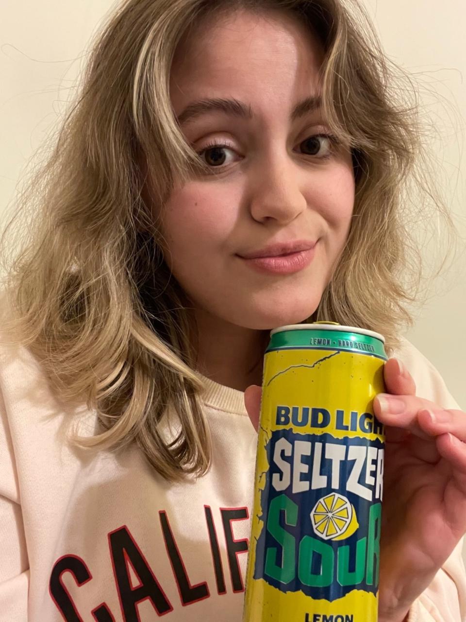 woman holding a seltzer