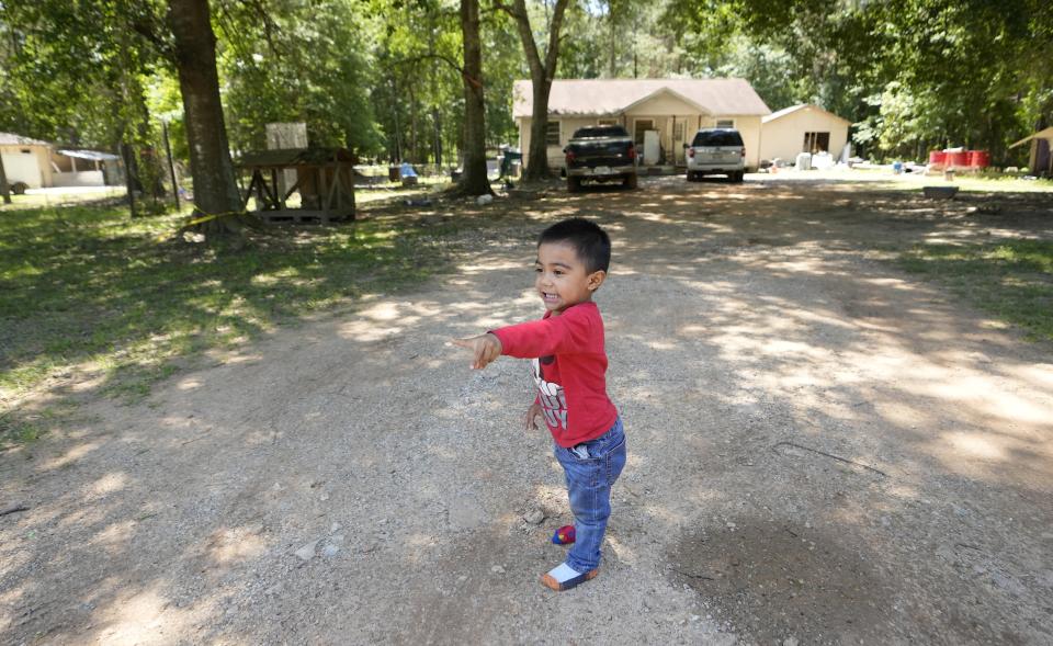 Josue Barcenas plays in his driveway, Sunday, April 30, 2023, across the street from the scene of a mass shooting Friday night, in Cleveland, Texas. The search for a Texas man who allegedly shot his neighbors after they asked him to stop firing off rounds in his yard stretched into a second day Sunday, with authorities saying the man could be anywhere by now. Francisco Oropeza, 38, fled after the shooting Friday night that left five people dead, including a young boy. (AP Photo/David J. Phillip)