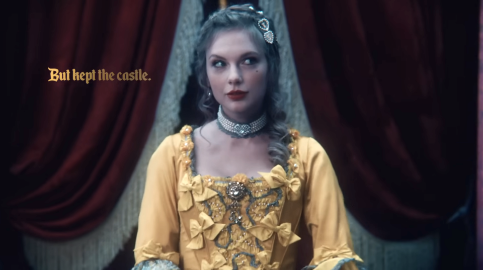 Taylor wearing a corseted dress with the caption "But kept the castle" next to her