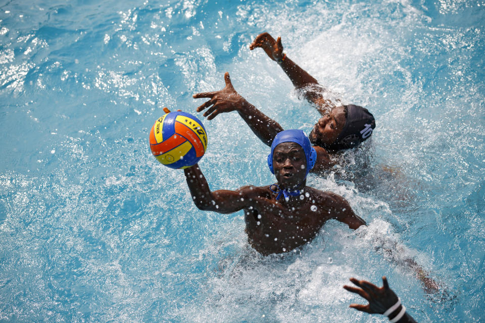 Two teams play water polo during an Awatu Winton Water Polo Club competition at the University of Ghana in Accra, Ghana, Saturday, Jan. 14, 2023. (AP Photo/Misper Apawu)