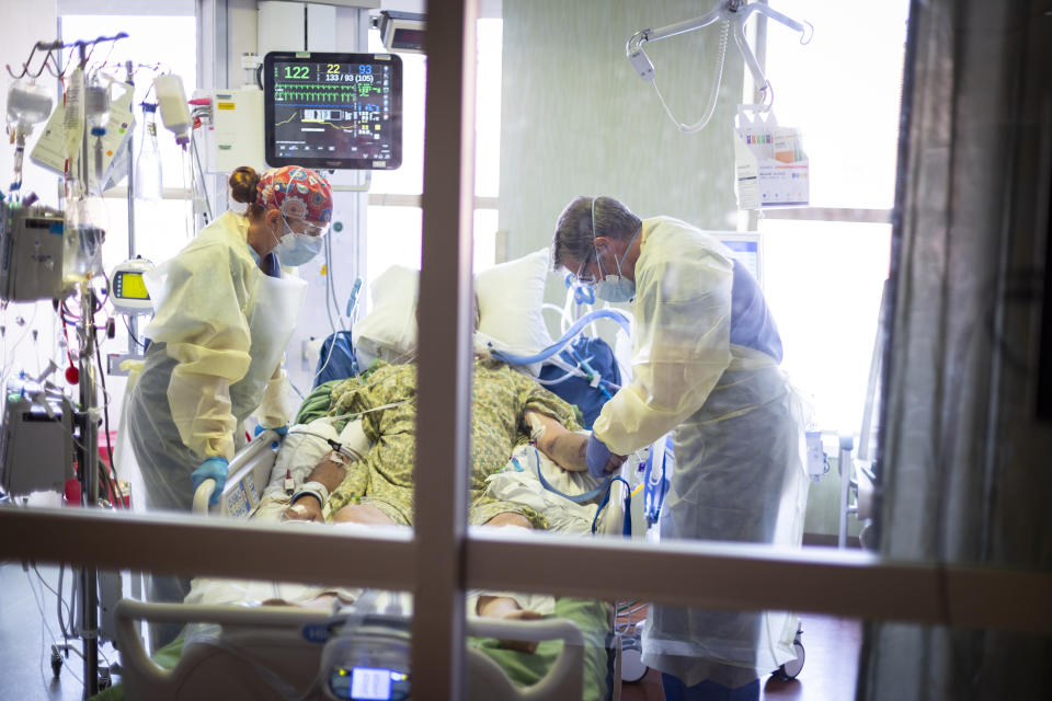 Dr. William Dittrich M.D. looks over a COVID-19 patient in the Medical Intensive care unit (MICU) at St. Luke's Boise Medical Center in Boise, Idaho on Tuesday, Aug. 31, 2021.. More then half of the patients in the ICU are COVID-19 positive, none of which are vaccinated. (AP Photo/Kyle Green)