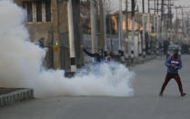 Kashmiri protesters clash with Indian paramilitary soldiers in Srinagar, Indian controlled Kashmir, Saturday, Dec. 15, 2018. At least seven civilians were killed and nearly two dozens injured when government forces fired at anti-India protesters in disputed Kashmir following a gunbattle that left three rebels and a soldier dead on Saturday, police and residents said. (AP Photo/Mukhtar Khan)