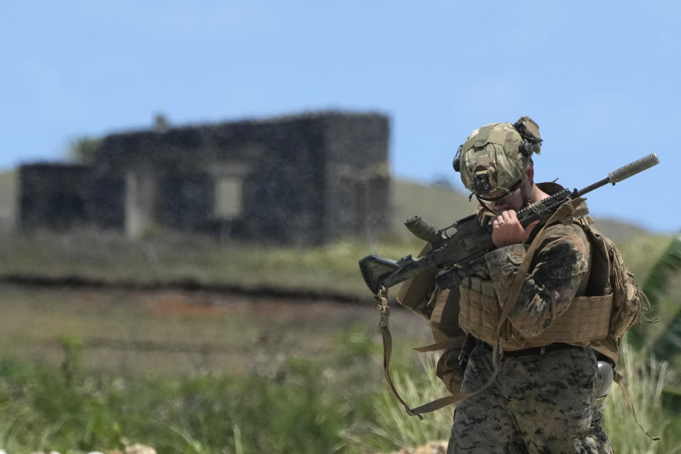 A U.S. trooper checks his rifle as they land at the Philippines' northernmost town of Itbayat, Batanes province during a joint military exercise on Monday, May 6, 2024. American and Filipino marines held annual combat-readiness exercises called Balikatan, Tagalog for shoulder-to-shoulder, in a show of allied battle readiness in the Philippines' northernmost island town of Itbayat along the strategic Bashi Channel off southern Taiwan. (AP Photo/Aaron Favila)