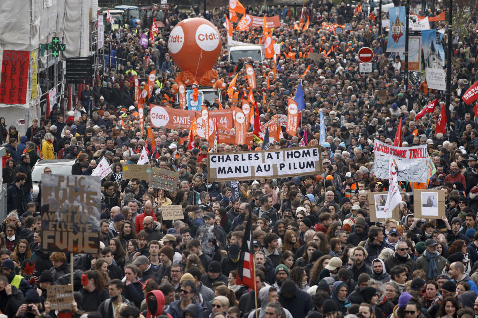 Workers demonstrate with a poster referring the King Charles III's canceled visit, Tuesday, March 28, 2023 in Nantes, western France. The fresh wave of strikes and protests is the 10th time since January that unions have called on workers to walk out and for demonstrators to flood the streets against Macron's push to move back France's legal retirement age from 62 to 64.(AP Photo/Jeremias Gonzalez)