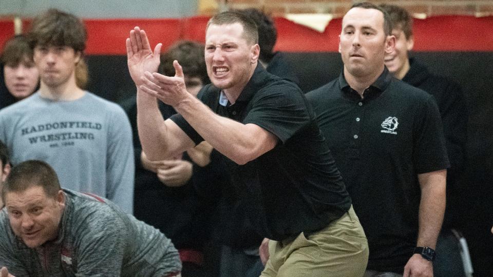 Haddonfield wrestling coach Eric Hamrick, center, celebrates during Haddonfield's 40-21 victory over Gloucester in the wresting meet held at Haddonfield Memorial High School on Friday, January 6, 2023.  