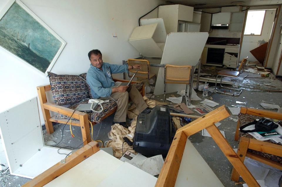 Kim Sengupta in the wreckage of his Baghdad hotel room, damaged in a car bomb attack  in 2005 (Getty)