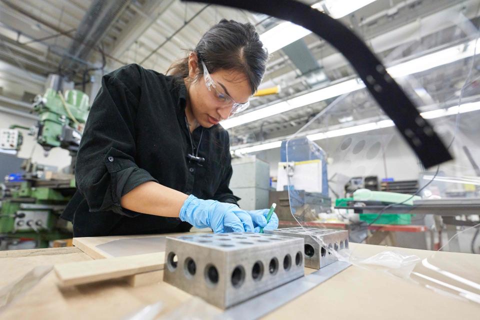 Kathleen Cornejo, project manager at University Machine Services works on assembling face shields for health care workers in the Faculty of Engineerings machine shop at Western University in London, Ontario on April 6, 2020. - The University has requested for about 14000 face shields and has partnered with local defence contractor General Dynamics to help produce them. (Photo by Geoff Robins / AFP) (Photo by GEOFF ROBINS/AFP via Getty Images)