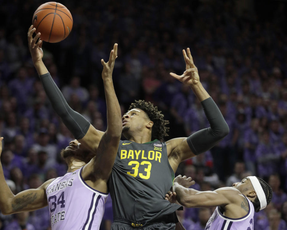 Baylor forward Freddie Gillespie (33) rebounds again Kansas State forwards Joe Petrakis (35) and Xavier Sneed, right, during the first half of an NCAA college basketball game in Manhattan, Kan., Monday, Feb. 3, 2020. (AP Photo/Orlin Wagner)