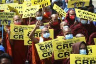 Buddhist monks displaying signs and flashing three-finger salutes lead an anti-coup protest march in Mandalay, Myanmar, Monday, March 1, 2021. Defiant crowds returned to the streets of Myanmar's biggest city on Monday, determined to continue their protests against the military's seizure of power a month ago, despite security forces having killed at least 18 people around the country just a day earlier. (AP Photo)